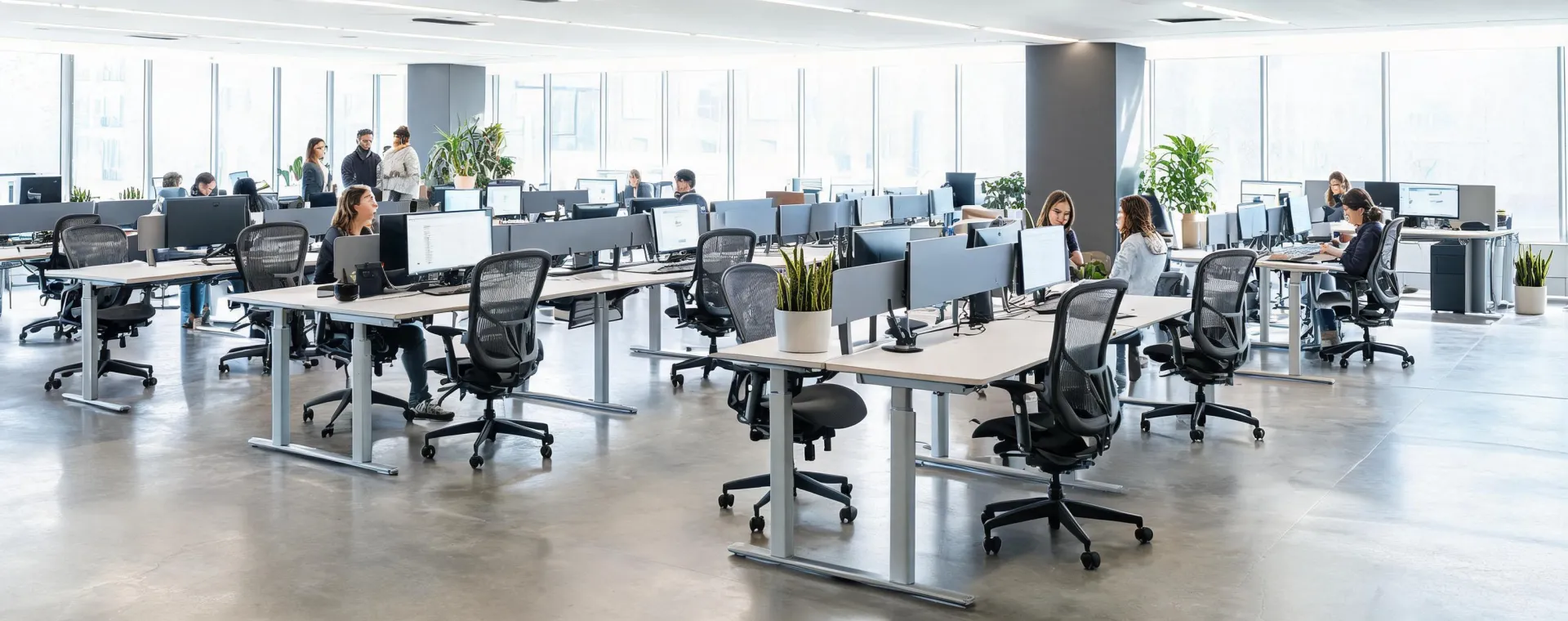 Modern open-plan office featuring Herman Miller ergonomic task seating and sit-stand desks