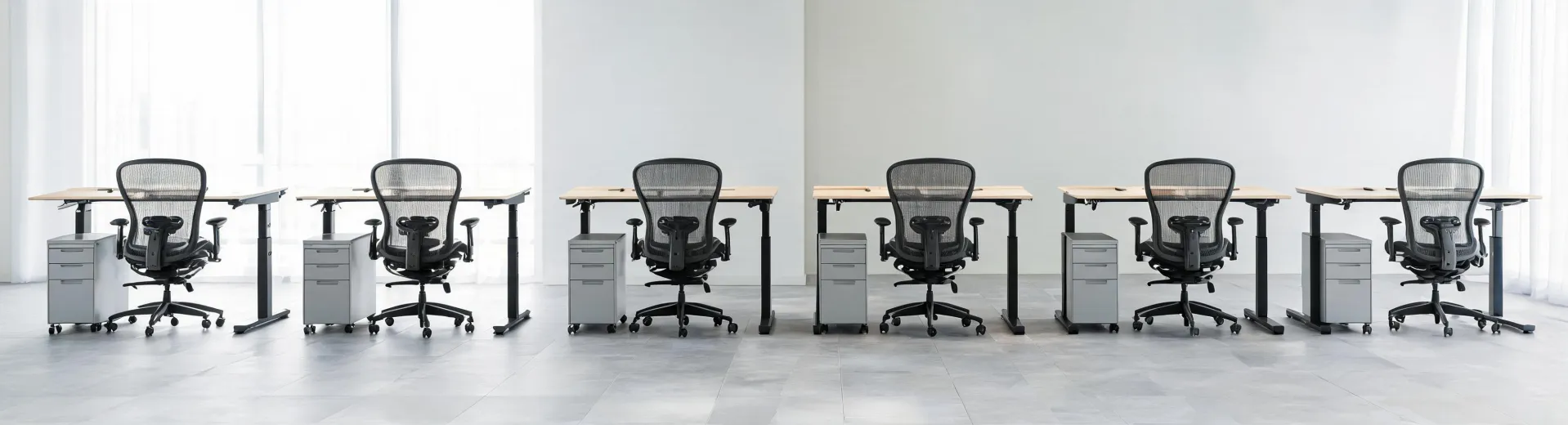 Office showroom with Herman Miller ergonomic task chairs and sit-stand desks arranged